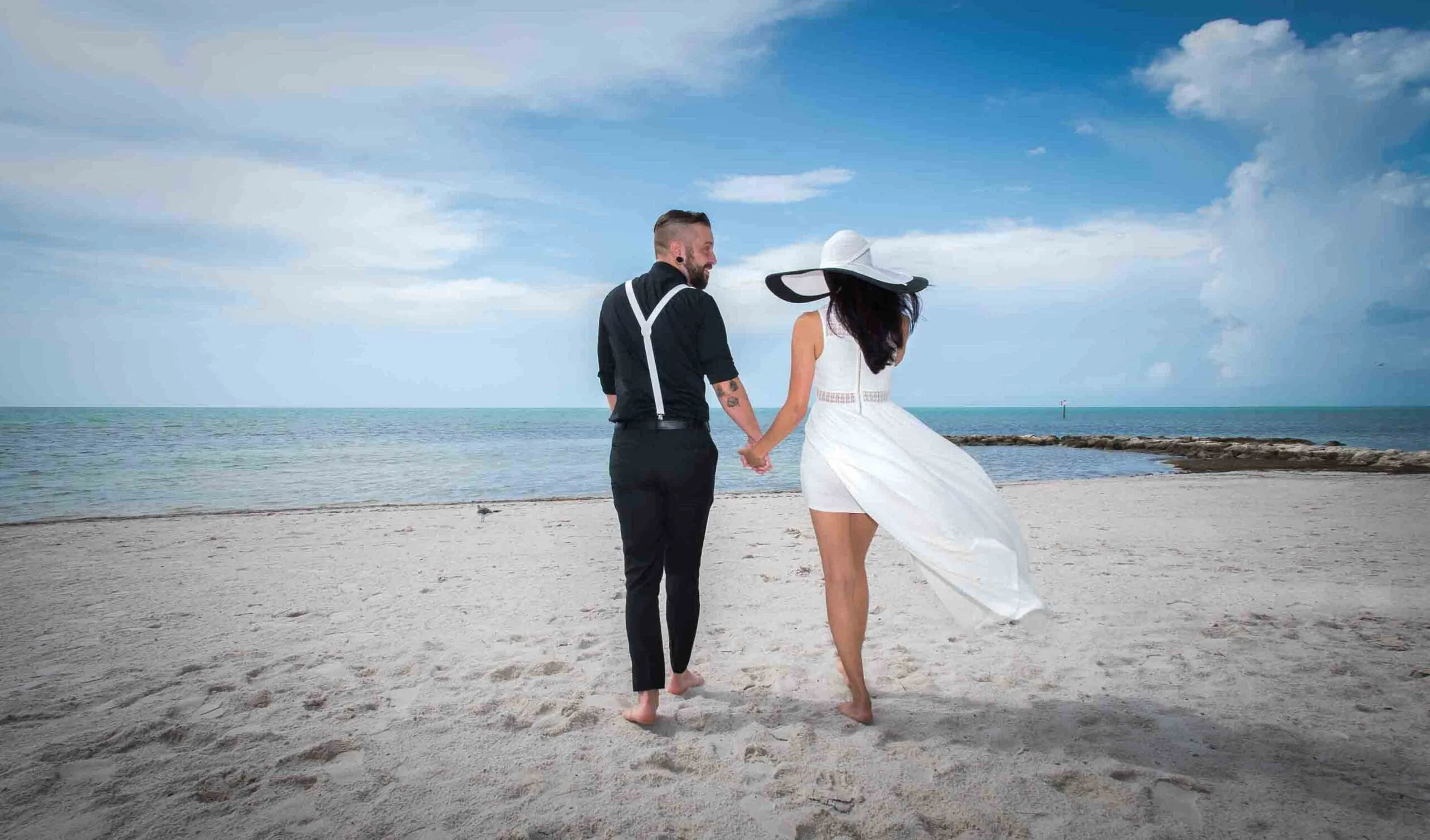Keywords used: key west wedding photographer, key west weddingDescription: A beautiful key west wedding captured by a talented photographer. The bride and groom are seen holding hands on the serene beach, with the