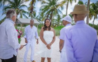 A beach wedding ceremony in Key West with a bride and groom, facilitated by experienced Key West wedding planners.
