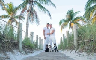 Two people standing on a wooden walkway with palm trees in the background, captured by a key west wedding photographer.