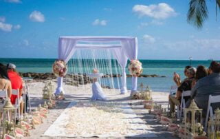 A picturesque beach wedding ceremony in Key West, organized by experienced wedding planners and conducted by a professional wedding officiant.