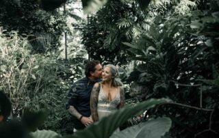 A bride and groom embrace in a tropical garden at their Key West wedding.