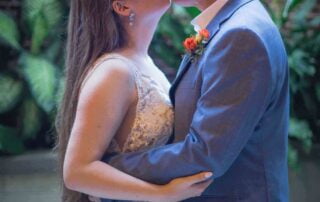 A bride and groom sharing an intimate kiss in a stunning courtyard captured by a talented Key West wedding photographer.