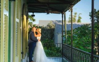 A bride and groom share a beautiful kiss on a balcony in New Orleans, captured by a talented Key West wedding photographer.