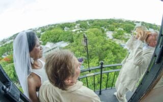 A bride and groom, with the assistance of a key west wedding planner, gazing out of a window at their beautiful wedding ceremony.