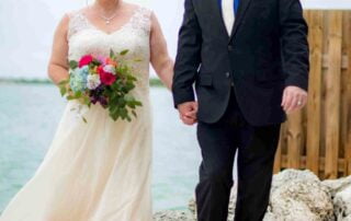 Key West wedding planners coordinate a picturesque ceremony for a bride and groom on the beach, with a skilled key west wedding officiant ensuring that their dream wedding comes to life.