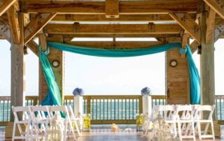 A romantic wedding ceremony set up on a deck overlooking the stunning ocean, captured beautifully by a talented Key West wedding photographer.