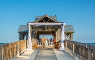 An enchanting wedding ceremony on a wooden pier in Florida, made even more memorable with the expertise of key west wedding planners.