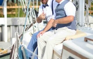 Two men sitting on a sailboat captured by a key west wedding photographer.