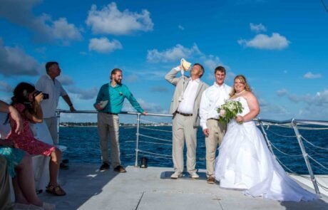 A picturesque boat wedding ceremony in Key West, expertly organized by our experienced Key West wedding planners. Our talented Key West wedding photographer will capture precious moments as the blissful bride and groom exchange