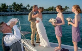 A bride and groom sharing a romantic kiss on the bow of a boat during their Key West wedding.