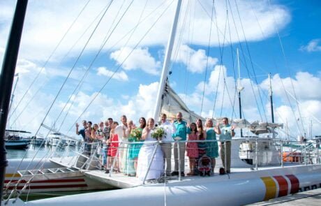 A group of people standing on the top of a boat during a Key West wedding ceremony.