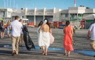 A group of people walking on the tarmac of an airport, captured by a skilled Key West wedding photographer.