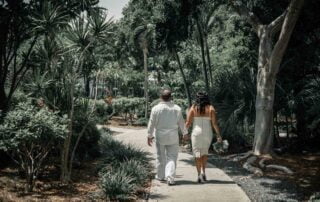 A key west bride and groom walking down a path captured beautifully by a key west wedding photographer.