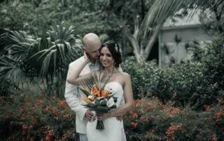 A bride and groom embracing in front of palm trees, captured beautifully by a Key West wedding photographer.