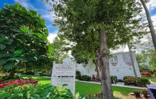 A house with trees and bushes in front of it, perfect for intimate Key West weddings.
