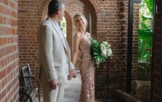 A bride and groom standing in an archway, captured beautifully by a talented Key West wedding photographer.