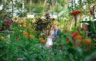 Key West wedding photographers capture a beautiful moment of a bride and groom posing in a garden.
