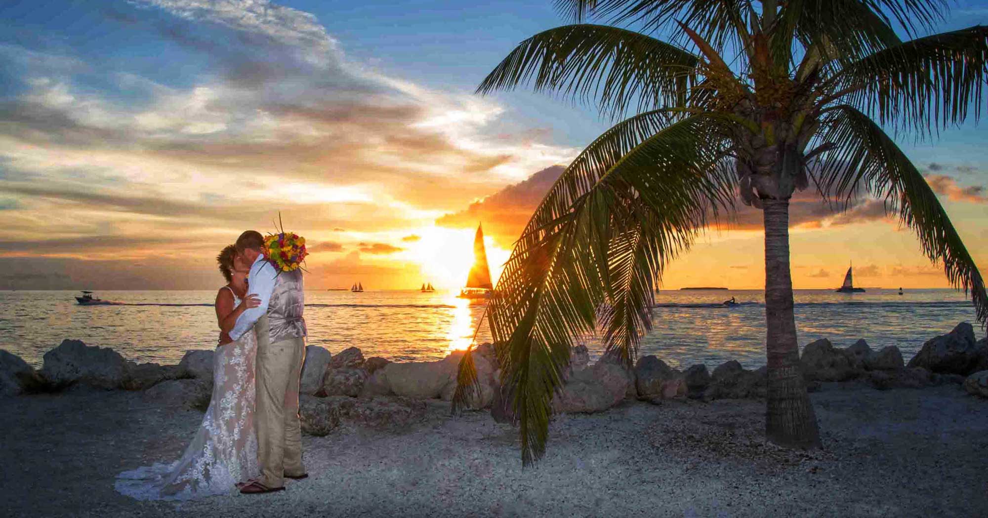 A breathtaking bride and groom enjoying a romantic moment on the picturesque beach at sunset.